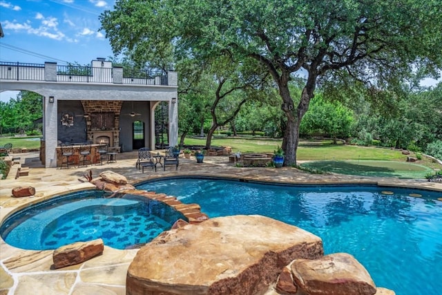 view of swimming pool featuring a patio, an in ground hot tub, and a yard