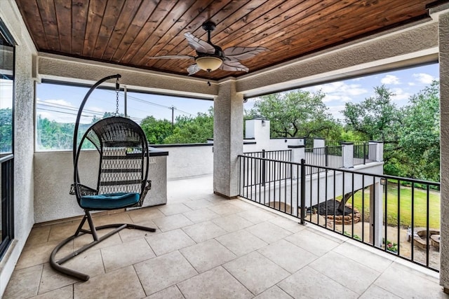 exterior space featuring ceiling fan and a balcony