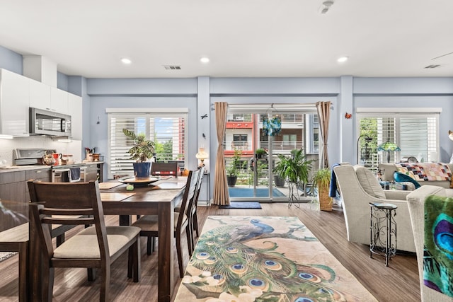 dining space featuring plenty of natural light and light hardwood / wood-style flooring