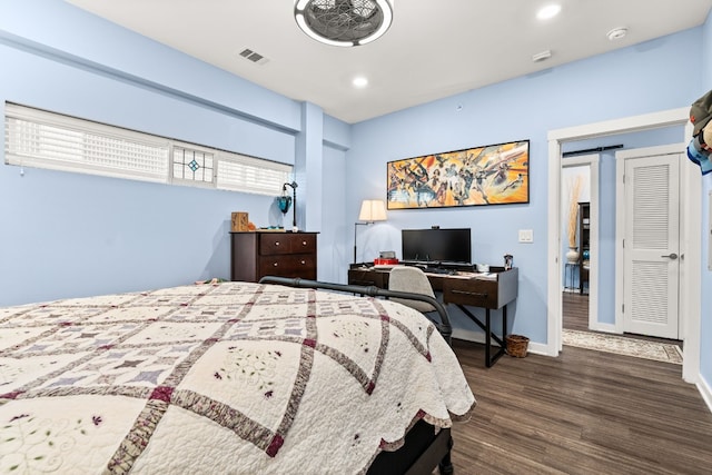 bedroom featuring dark hardwood / wood-style flooring