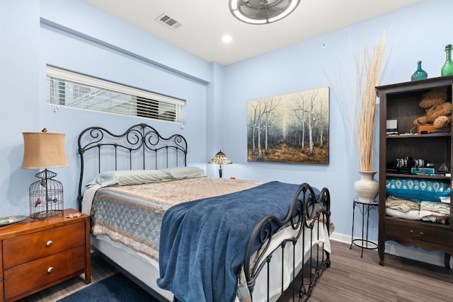 bedroom with dark hardwood / wood-style floors