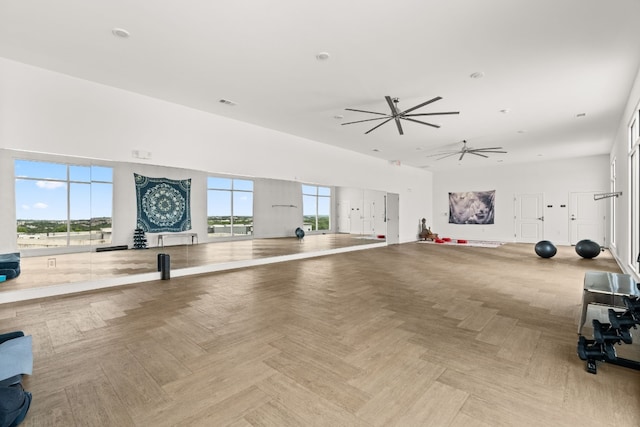 interior space with ceiling fan and light parquet flooring