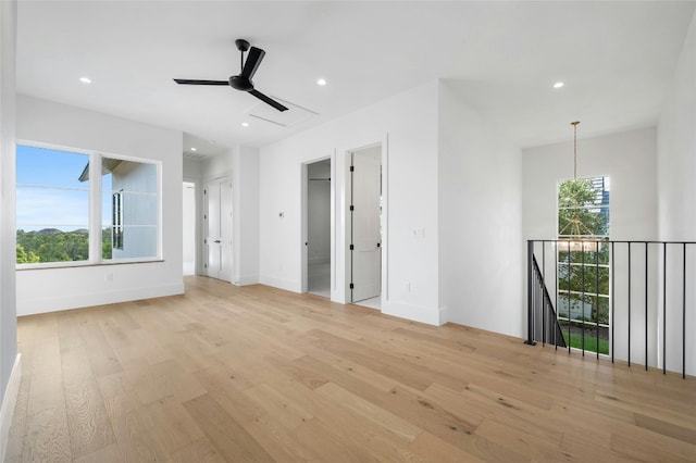 spare room with light wood-style floors, baseboards, and recessed lighting