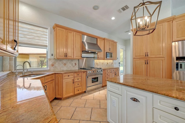 kitchen with pendant lighting, sink, wall chimney exhaust hood, appliances with stainless steel finishes, and tasteful backsplash