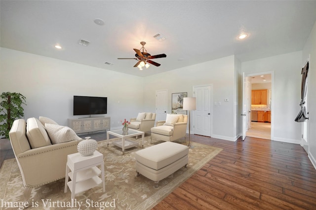 living room featuring hardwood / wood-style flooring and ceiling fan