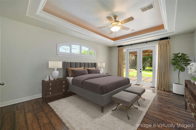 bedroom with access to exterior, ceiling fan, french doors, dark hardwood / wood-style flooring, and a tray ceiling