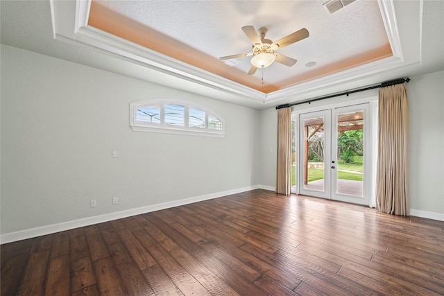 spare room with french doors, a raised ceiling, and a wealth of natural light