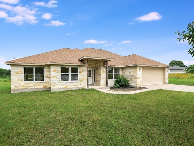 view of front of home featuring a garage and a front lawn