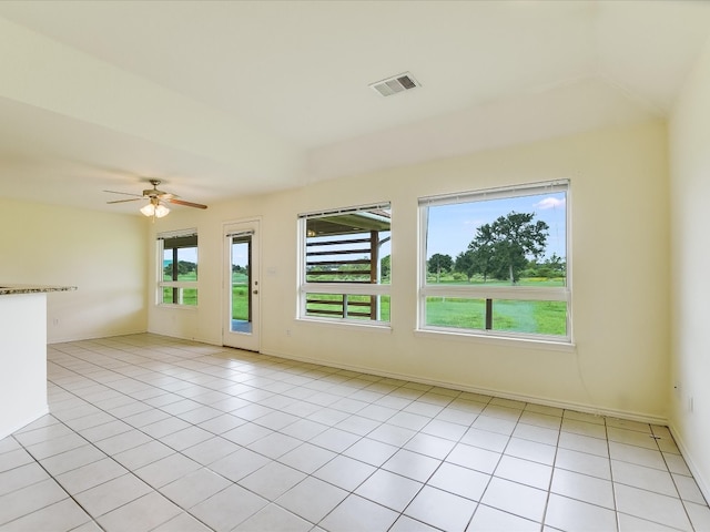 tiled empty room featuring ceiling fan