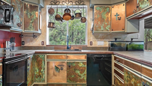 kitchen with sink, a wealth of natural light, black appliances, and tile counters