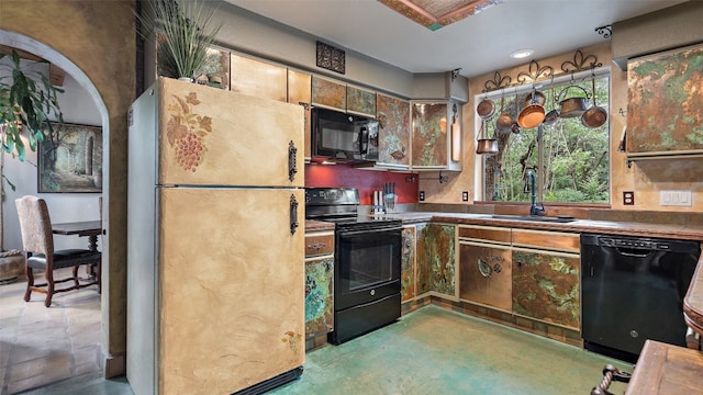 kitchen featuring sink, black appliances, and tasteful backsplash