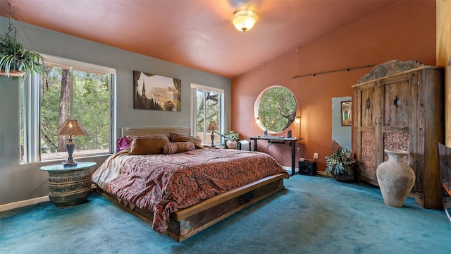 carpeted bedroom featuring high vaulted ceiling