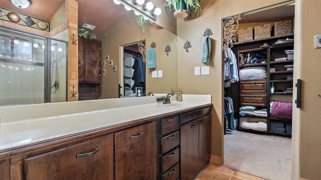 bathroom featuring walk in shower, tile flooring, vanity, and vaulted ceiling