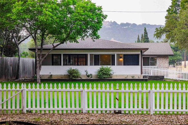 single story home featuring a front yard and a mountain view