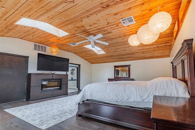 bedroom with wooden ceiling, ceiling fan, dark hardwood / wood-style floors, and vaulted ceiling with skylight