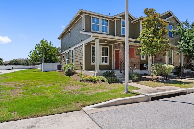 view of front facade with a front lawn and central AC unit