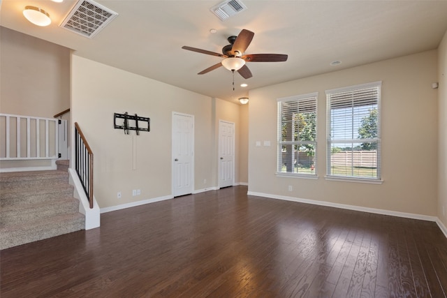 unfurnished living room with ceiling fan and dark carpet