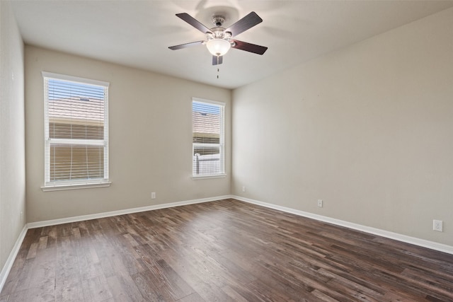 empty room featuring ceiling fan and dark wood-type flooring