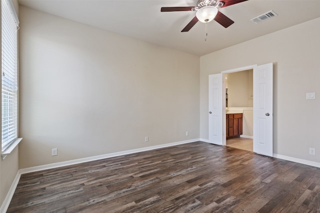 spare room featuring dark hardwood / wood-style floors and ceiling fan