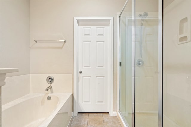 bathroom with tile flooring and separate shower and tub