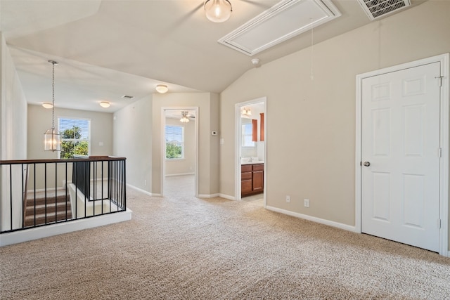 carpeted spare room featuring lofted ceiling