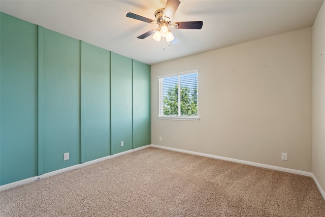 carpeted empty room with ceiling fan