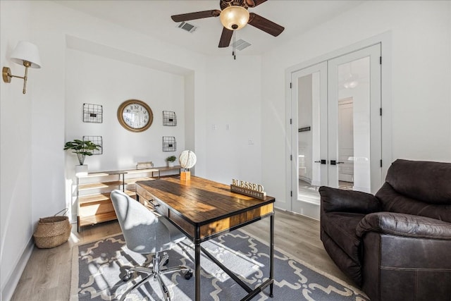 office space featuring french doors, light hardwood / wood-style flooring, and ceiling fan