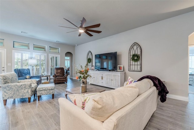 living room with ceiling fan and light wood-type flooring