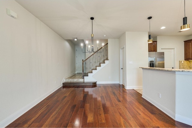 interior space with a chandelier and dark wood-type flooring