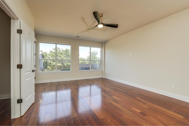 empty room featuring dark hardwood / wood-style floors and ceiling fan