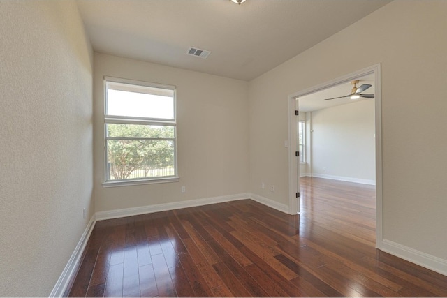 spare room featuring ceiling fan and dark hardwood / wood-style flooring