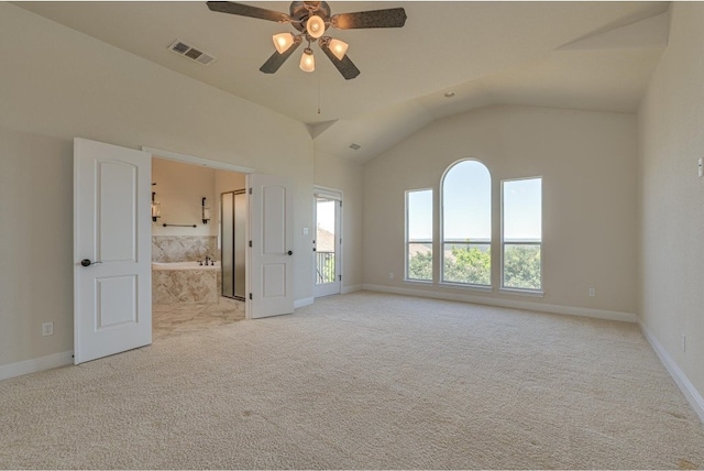 carpeted empty room with vaulted ceiling and ceiling fan