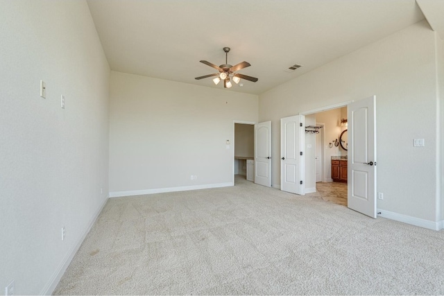 unfurnished bedroom with ceiling fan and light colored carpet