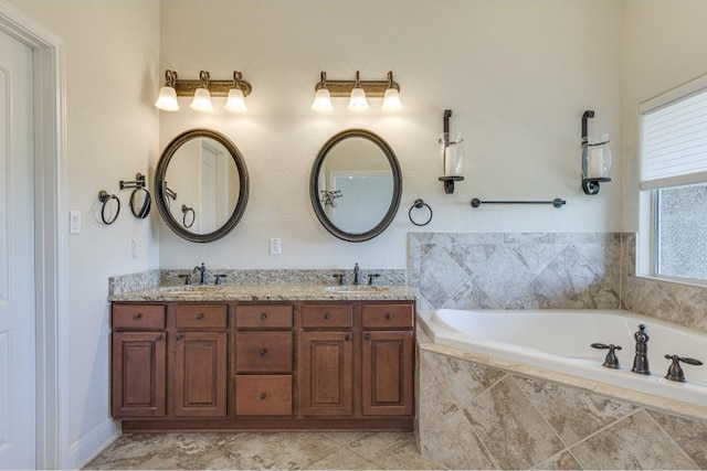 bathroom with tiled bath and vanity