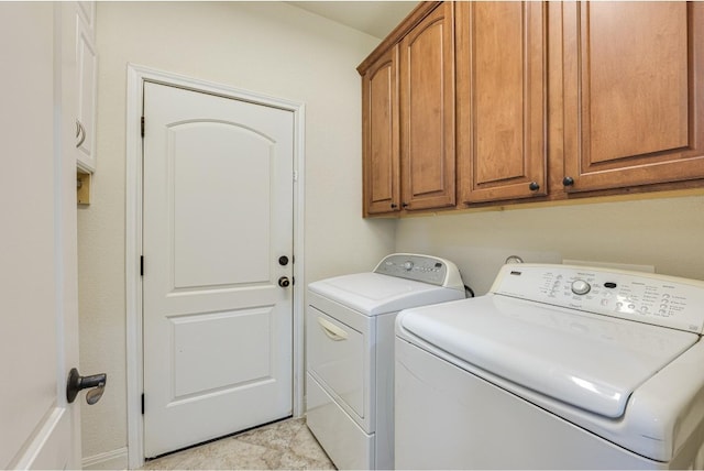 laundry area featuring cabinets and washing machine and clothes dryer