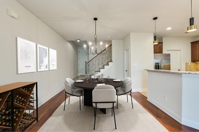 dining room featuring dark wood-type flooring and a chandelier