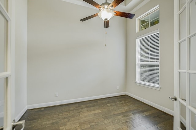 empty room with dark wood-type flooring and ceiling fan