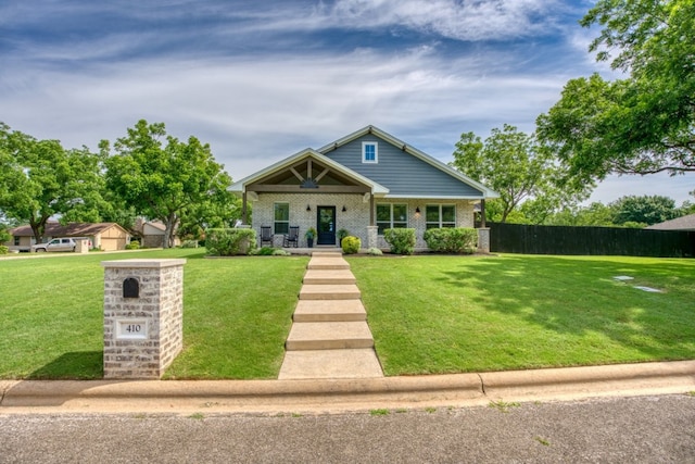 craftsman-style home with a porch and a front yard