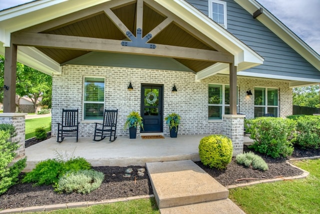 view of exterior entry featuring a porch