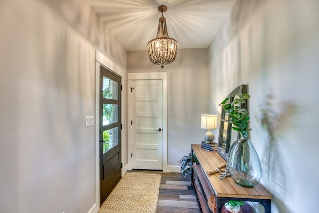 entryway featuring dark hardwood / wood-style flooring and a chandelier