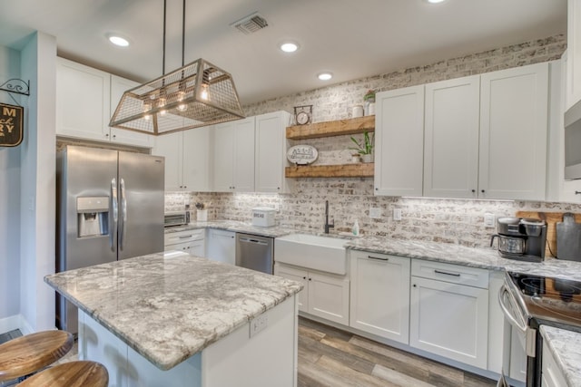 kitchen featuring white cabinetry and sink