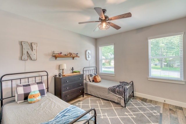 bedroom featuring hardwood / wood-style flooring and ceiling fan