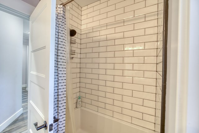 bathroom featuring shower / tub combo with curtain and wood-type flooring