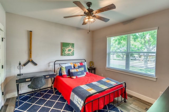 bedroom with ceiling fan and wood-type flooring