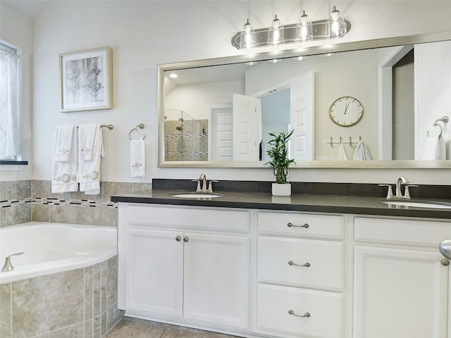 bathroom featuring vanity and shower with separate bathtub