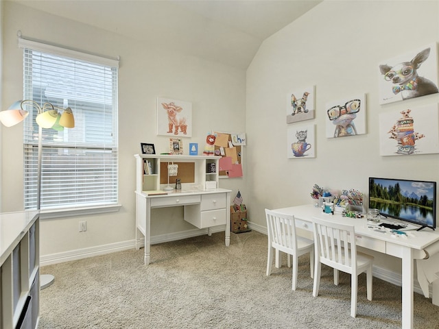 carpeted office space featuring vaulted ceiling