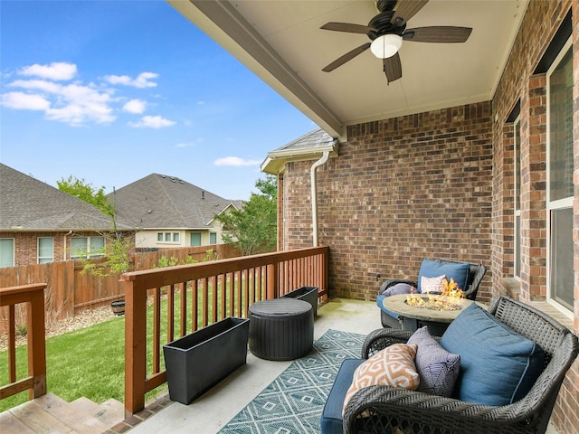 deck featuring a yard and ceiling fan