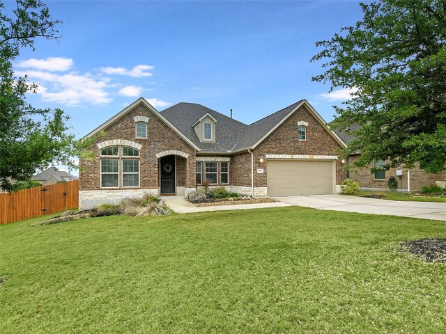 view of front of home featuring a garage and a front lawn