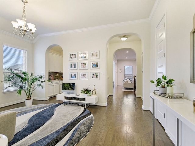 hall with ornamental molding, dark hardwood / wood-style flooring, and a chandelier