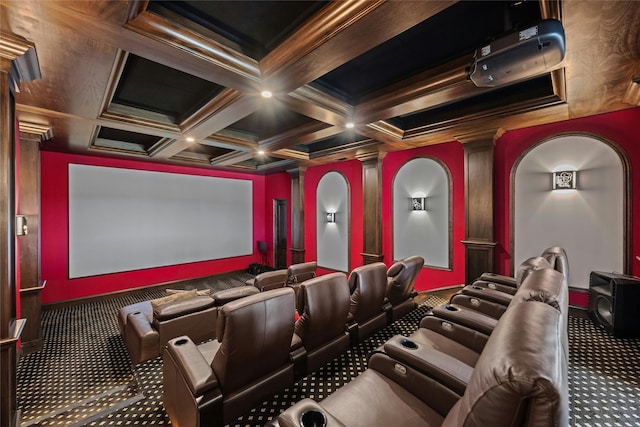 home theater room with ornate columns, coffered ceiling, carpet, ornamental molding, and beamed ceiling